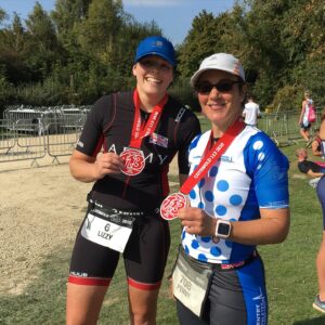 Triathletes with their finisher medals at the end of racing a middle distance triathlon