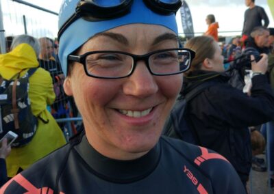 Coach Penny in her wetsuit, swim hat and goggles ready for Ironman Triathlon