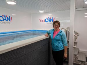 Swimming teacher next to swimming pool