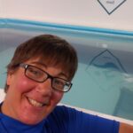 Swimming teacher stood next to swimming pool